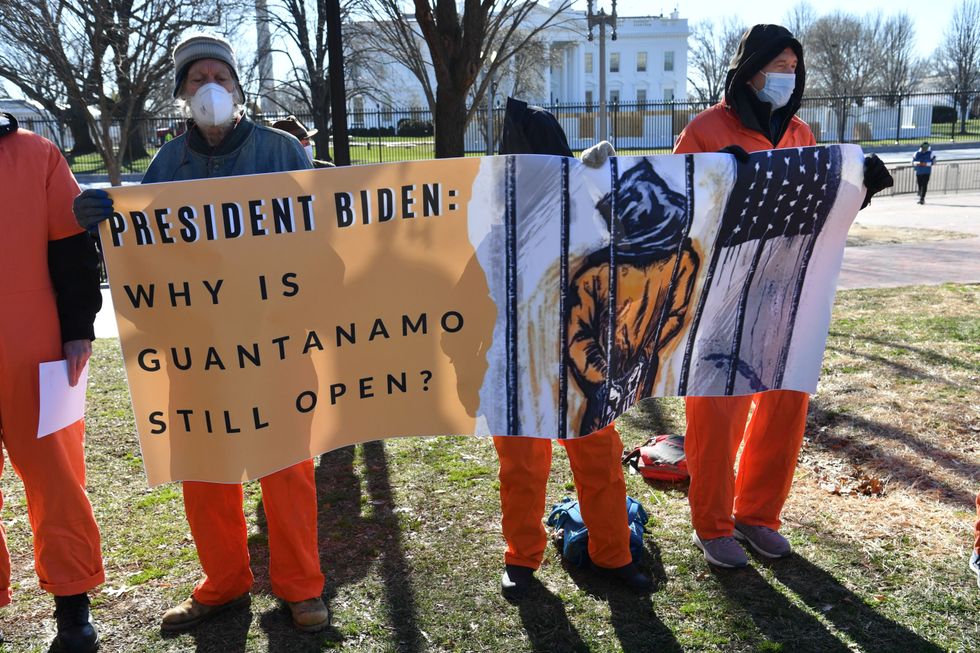 Demonstrators hold a sign during a protest calling for the closure of Guant\u00e1namo.