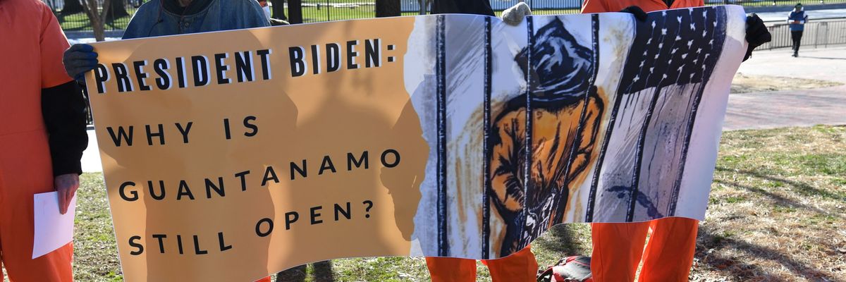 Demonstrators hold a sign during a protest calling for the closure of Guantánamo in front of the White House in Washington, D.C. on January 11, 2022.