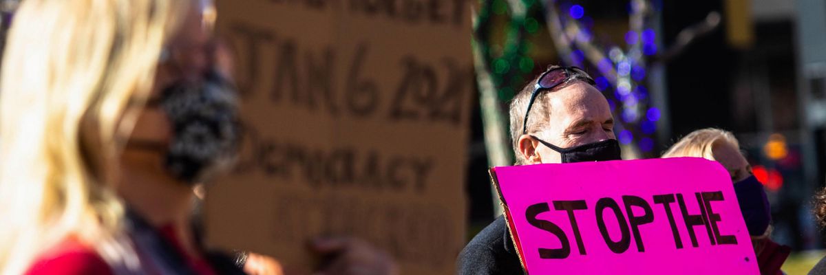 Demonstrators hold signs during a protest in Nevada