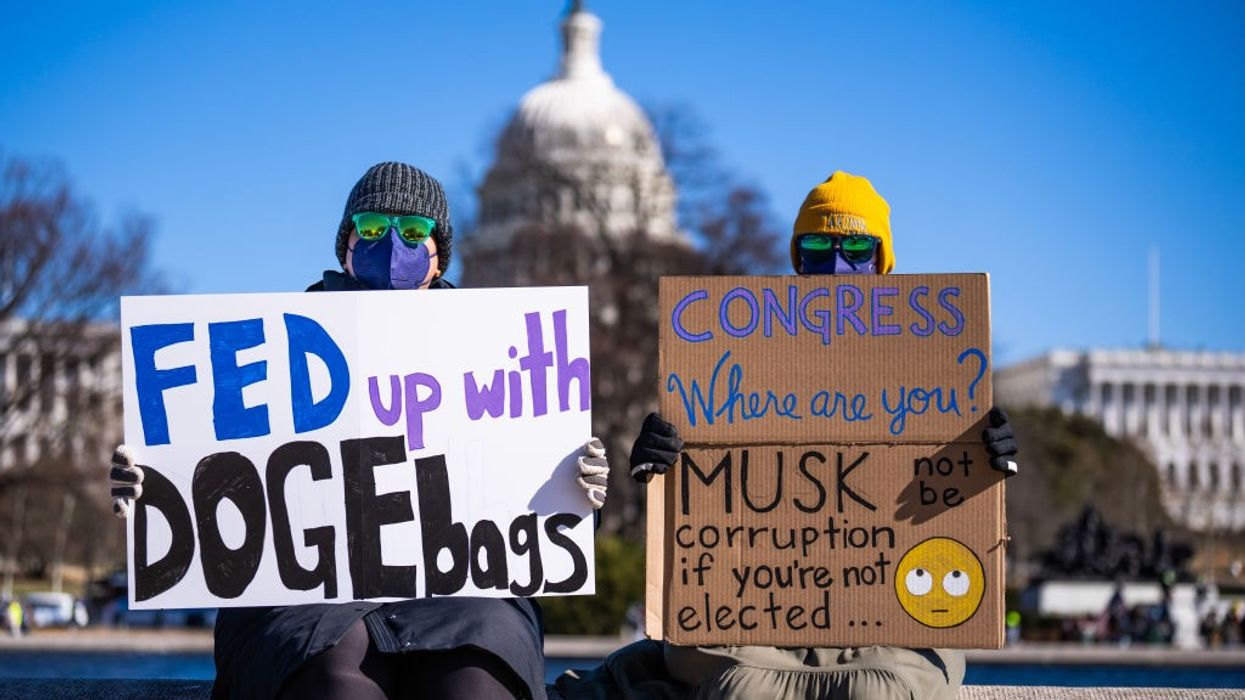 Demonstrators hold signs during a protest