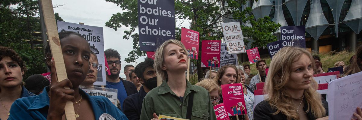 Demonstrators hold signs during an abortion rights protest in London
