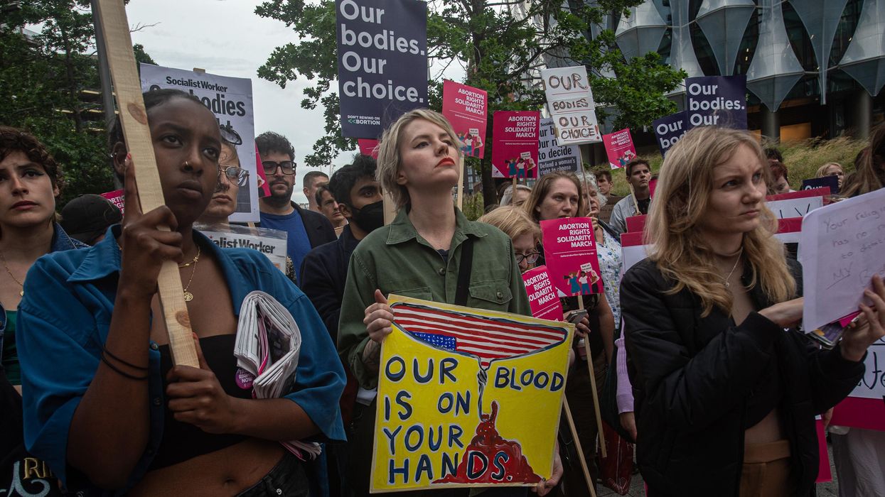 Demonstrators hold signs during an abortion rights protest in London