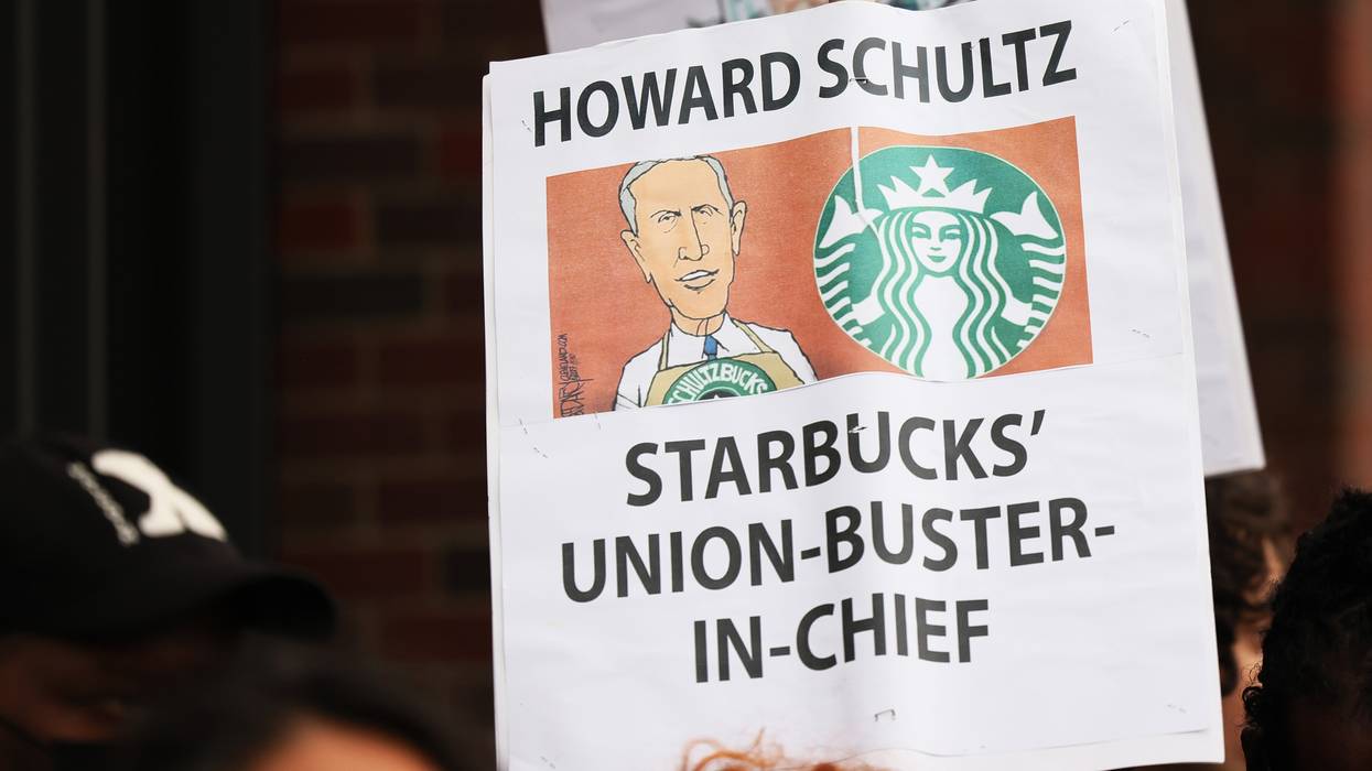 Demonstrators hold signs while protesting in front of a Starbucks shop on April 14, 2022 in New York City. 