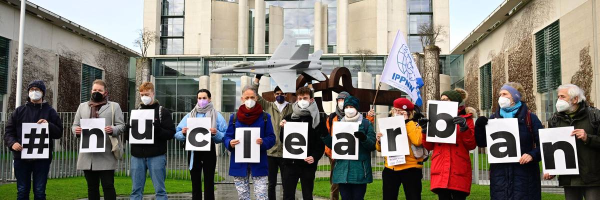 Demonstrators holding a sign that reads "#nuclearban"