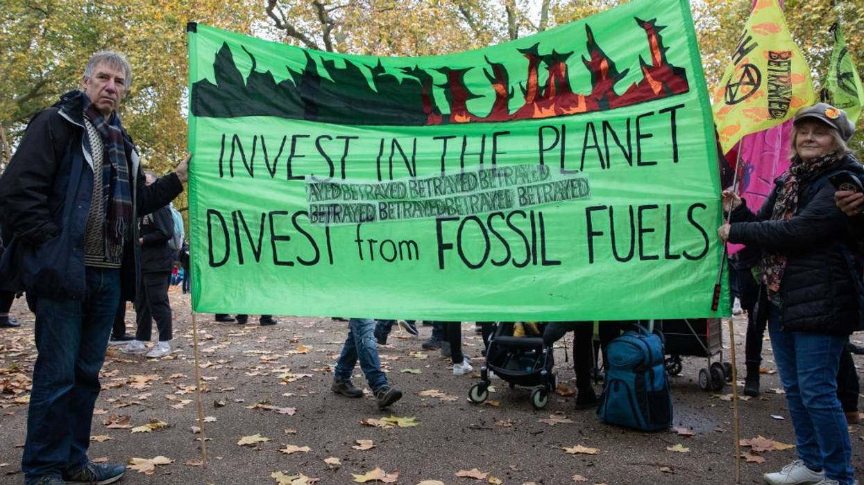 Demonstrators holding sign that reads: "Invest in the planet / Divest from Fossil Fuels"