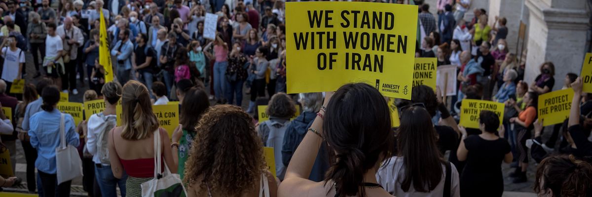 Demonstrators in Italy with signs that say "We Stand With Women of Iran"