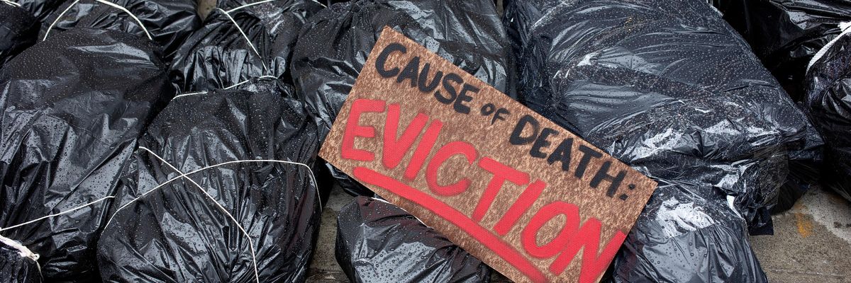 Demonstrators line up mock body bags during a protest