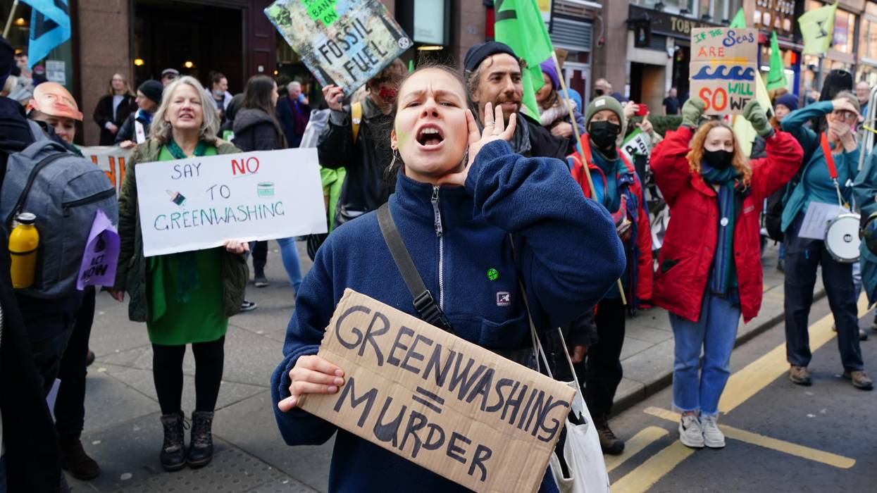 Demonstrators march down Hope Street in Glasgow, Scotland, on November 3, 2021 for a march against greenwashing organized by Extinction Rebellion during COP26.