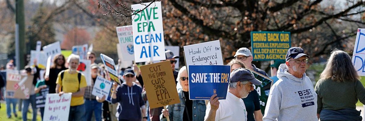 Demonstrators march during a "Hands off the EPA" rally