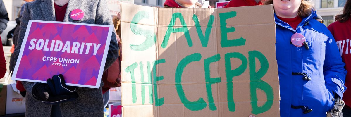 Demonstrators protest against cuts to the U.S. Consumer Financial Protection Bureau