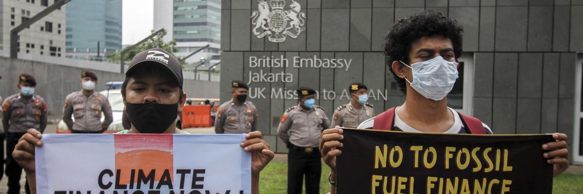 Demonstrators protest fossil fuel funding at the British Embassy in Jakarta.