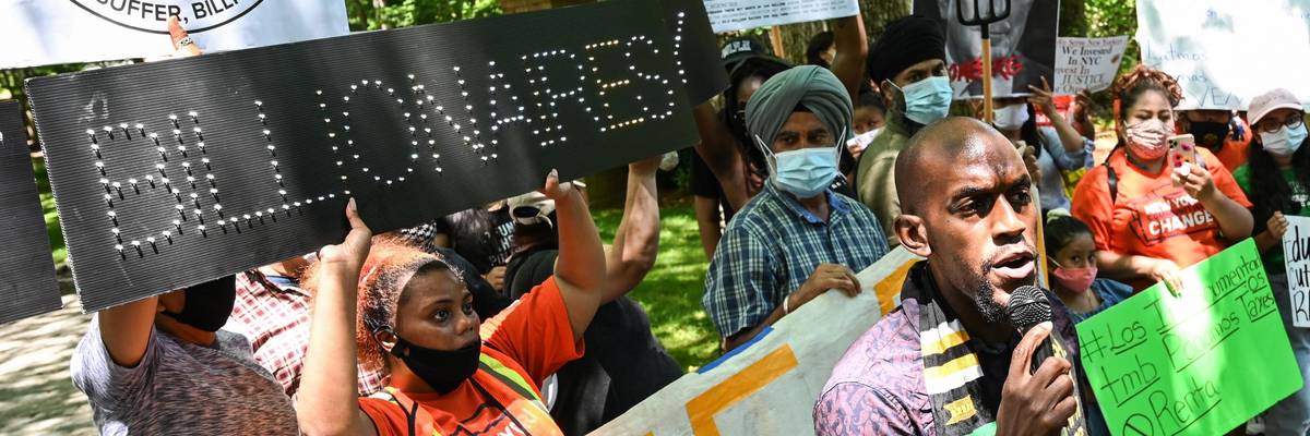 Demonstrators protest outside of Michael Bloomberg's home