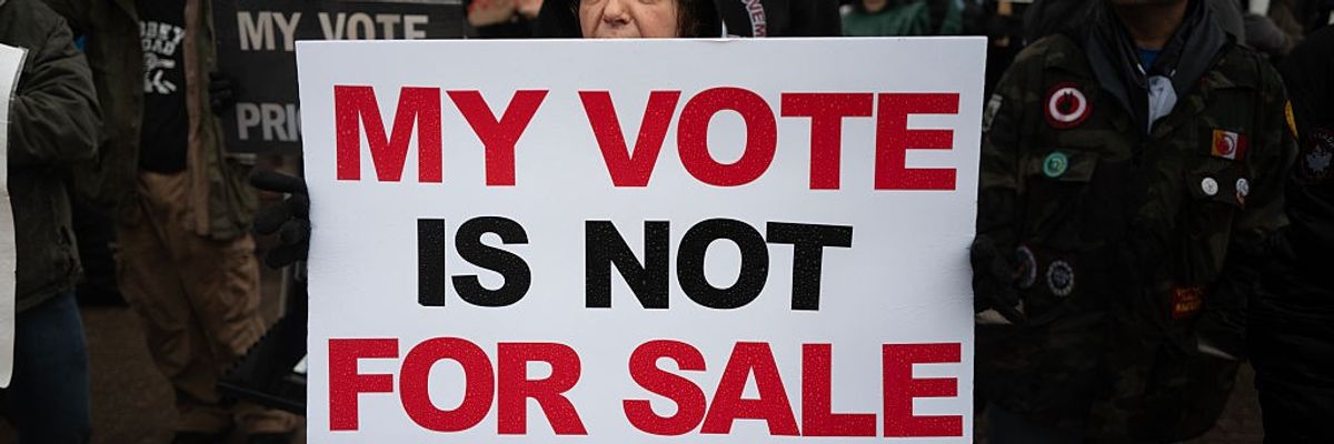 Demonstrators protest outside the KI Convention Center before the start of a town hall meeting with Elon Musk
