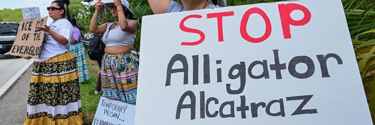 Demonstrators protest the construction of an immigrant detention center, dubbed "Alligator Alcatraz,"