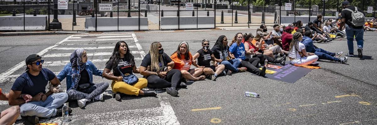 Demonstrators sit in at a protest to end the filibuster