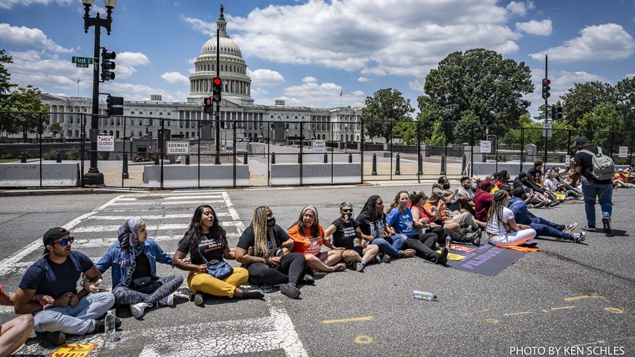 Demonstrators sit in at a protest to end the filibuster