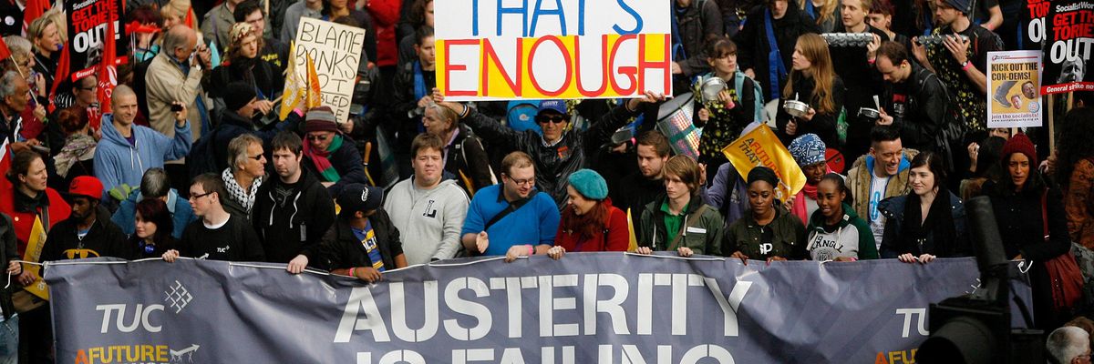 Demonstrators take part in a protest against UK government's austerity