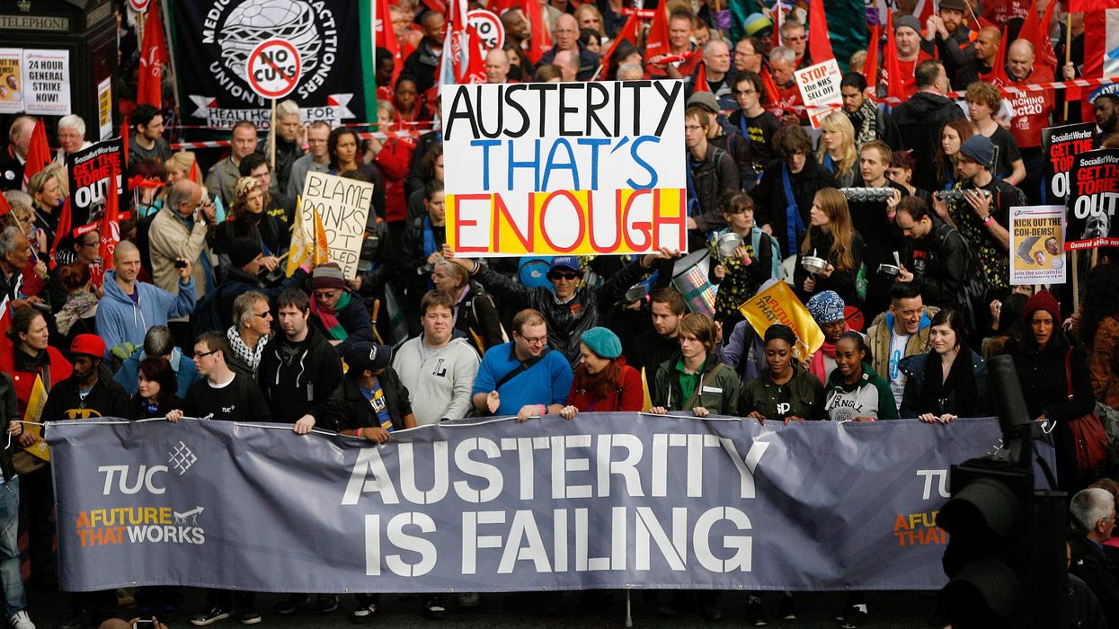 Demonstrators take part in a protest against UK government's austerity