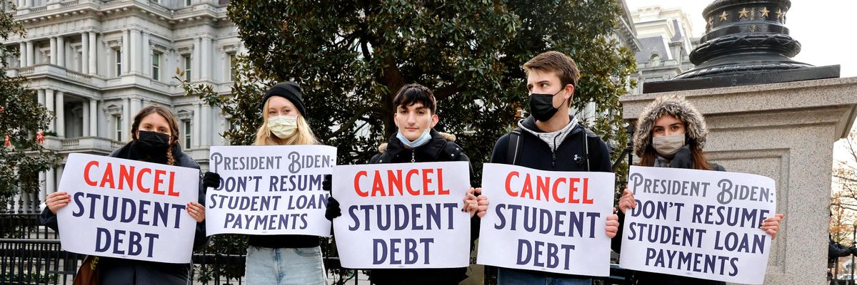 Demonstrators urge President Joe Biden to cancel student debt.