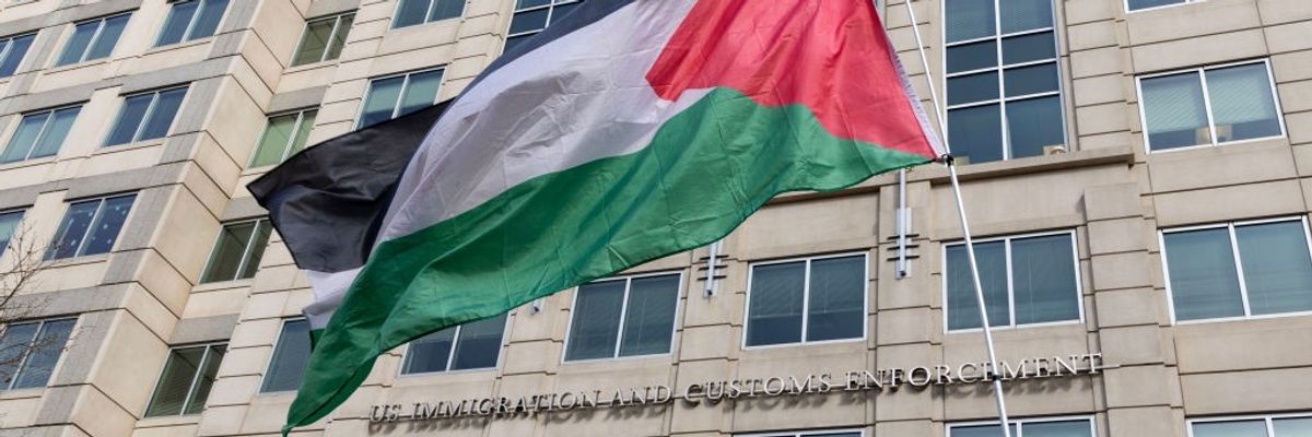 Demonstrators wave a Palestinian flag outside ICE headquarters.