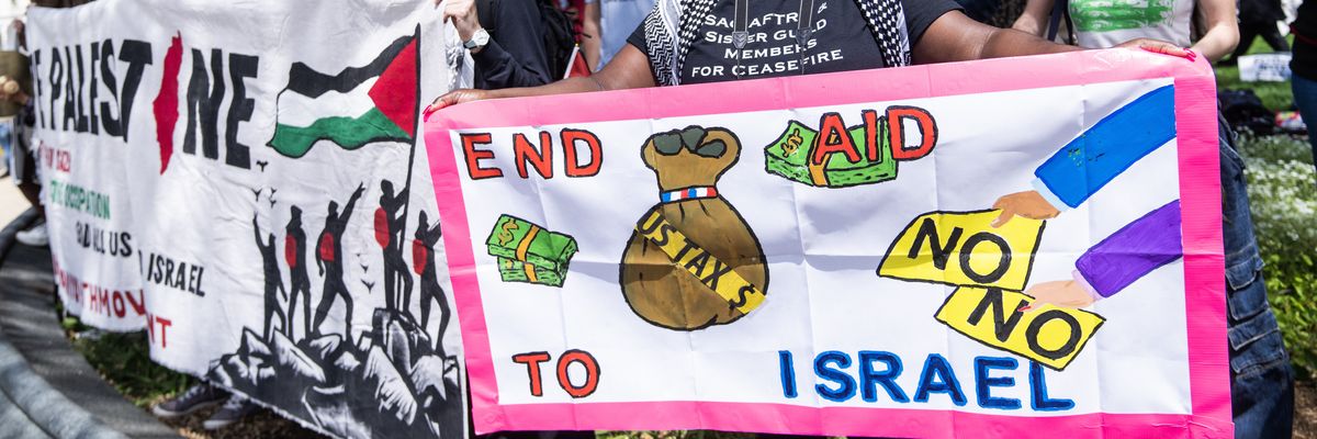 Demonstrators with posters calling for no funding for Israel. 