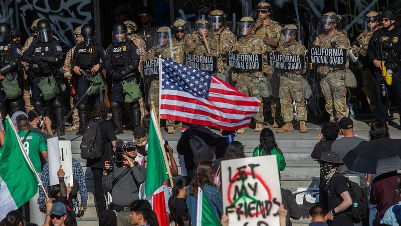 Demonstrators with U.S. and Mexican flags face off against National Guard in LA.