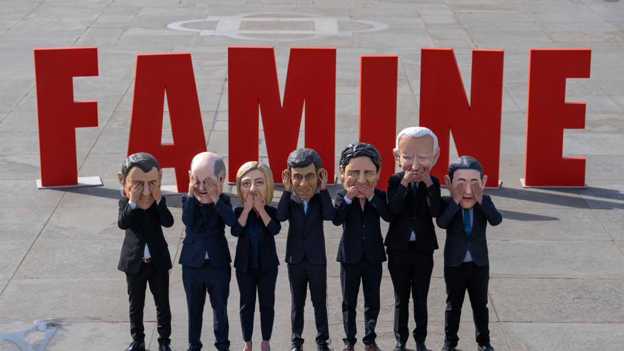 depictions of G7 leaders in front of 'FAMINE'