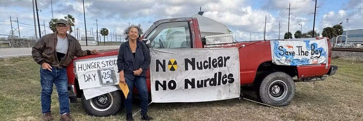 Diane Wilson poses with truck and signs during hunger strike against Dow.