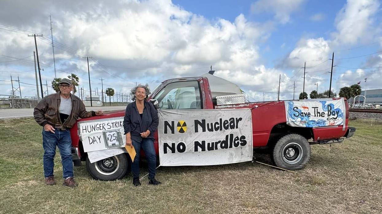 Diane Wilson poses with truck and signs during hunger strike against Dow.
