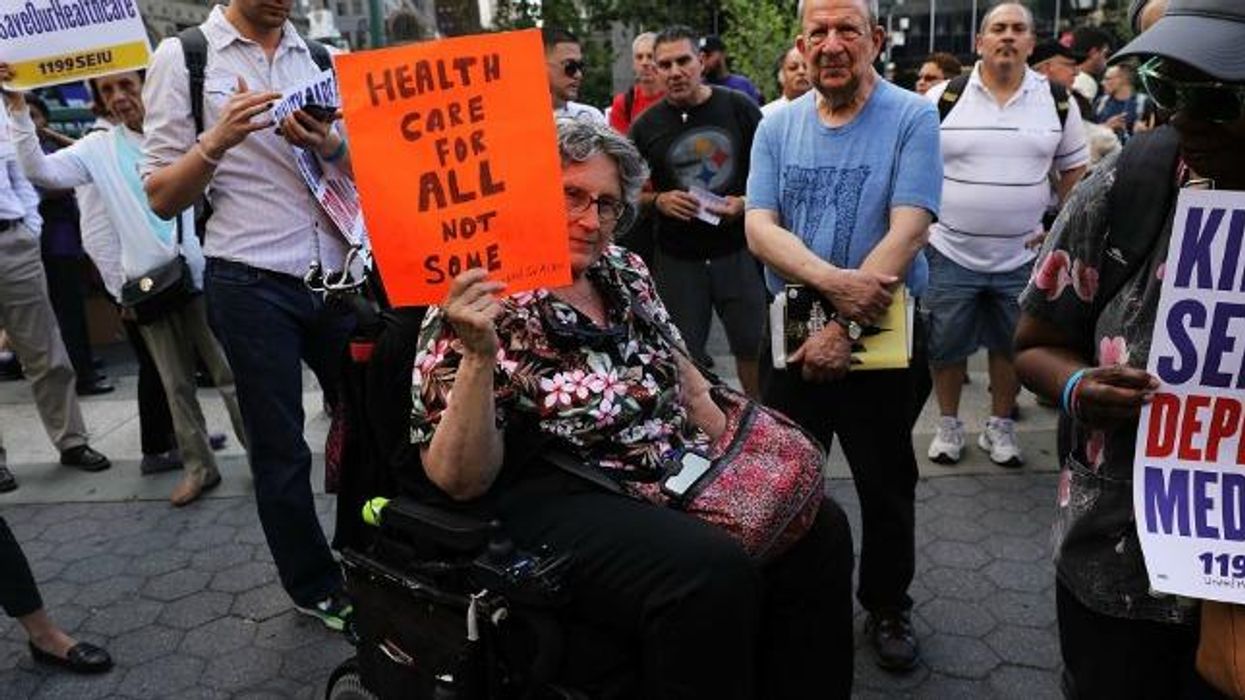 Disability rights advocate holds sign.