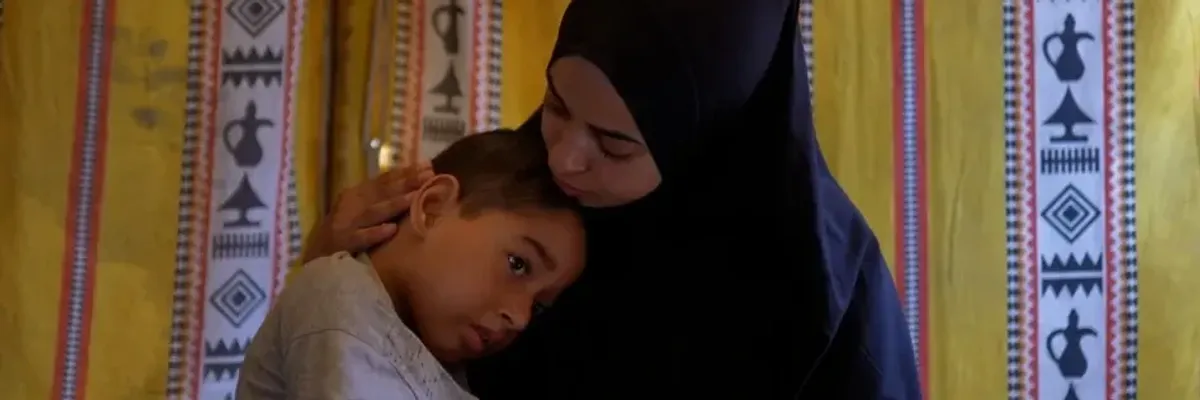 Disabled child and mother in Gaza.
