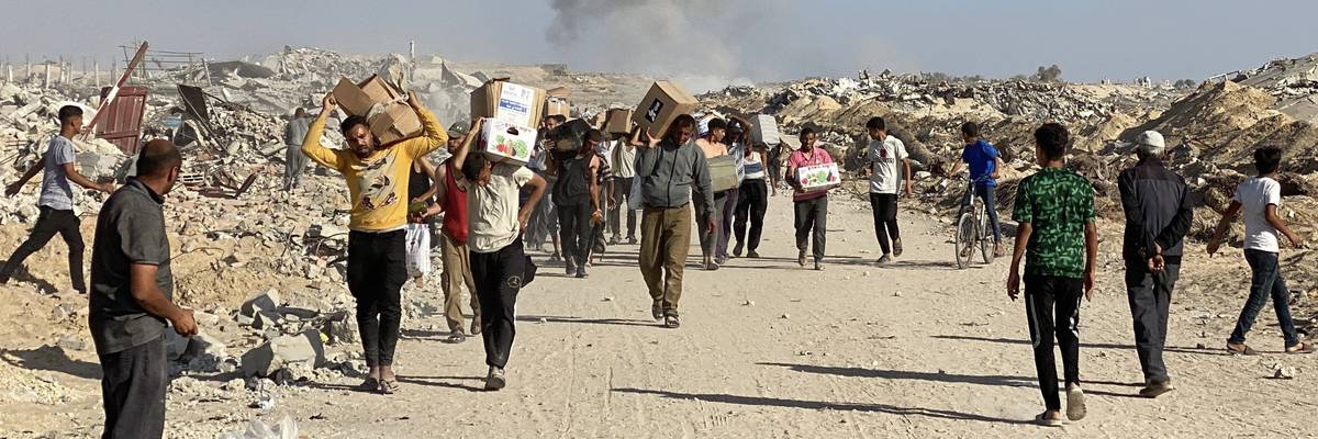 Displaced Palestinians receive food packages from a U.S.-backed foundation