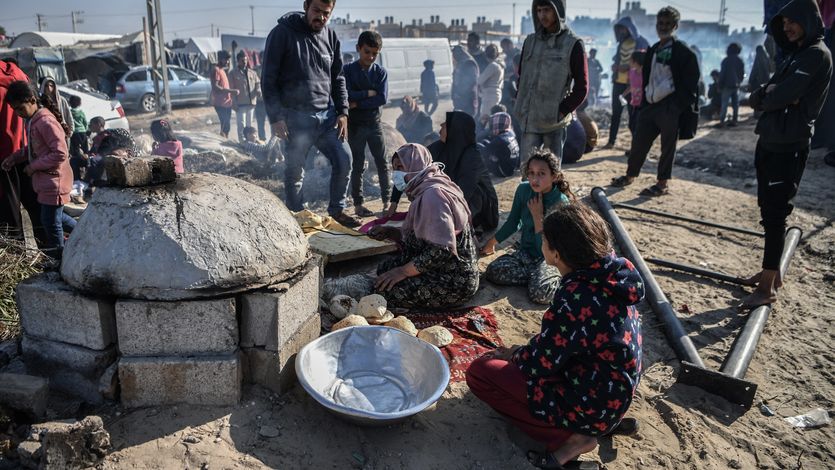 Displaced people prepare food in Gaza