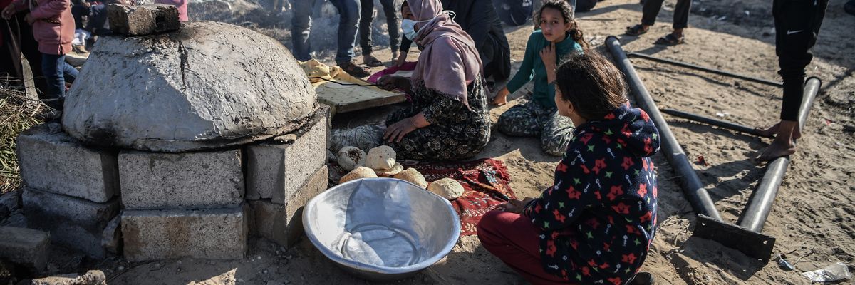 Displaced people prepare food in Gaza