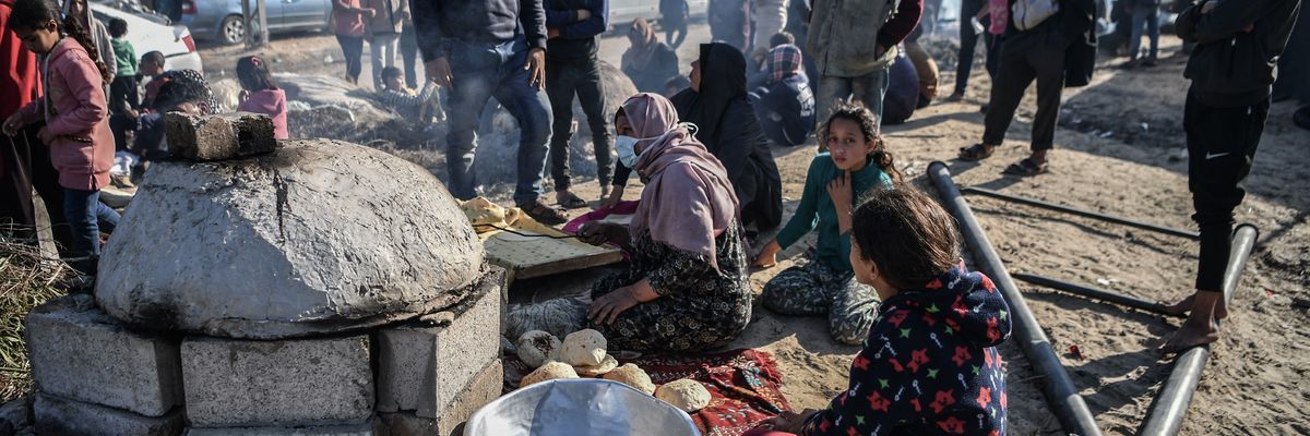 Displaced people prepare food in Gaza