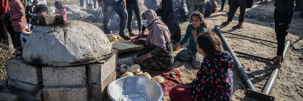 Displaced people prepare food in Gaza