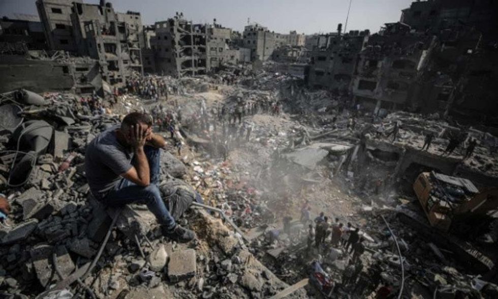 Distraught Palestinian looks out over the rubble of Gaza's Jabalia Refugee Camp after Israel airstrikes