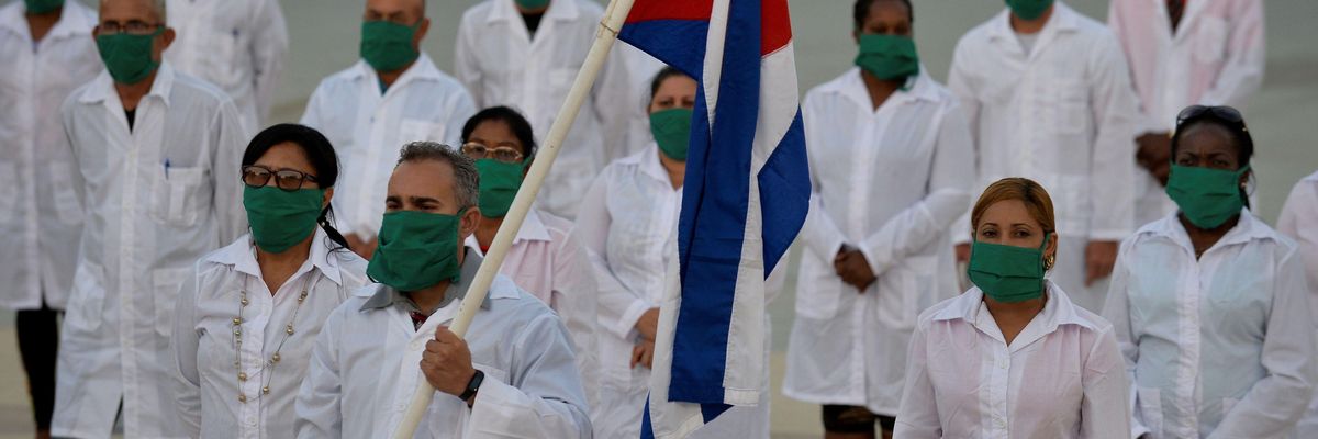Doctors and nurses of Cuba's Henry Reeve International Medical Brigade take part in a farewell ceremony before traveling to Andorra to help in the fight against the Covid-19 pandemic, at the Central Unit of Medical Cooperation in Havana, on March 28, 2020. 