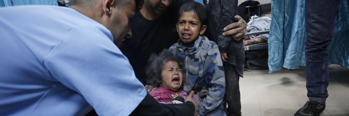 Doctors at Al-Aqsa Martyrs Hospital examine Palestinians