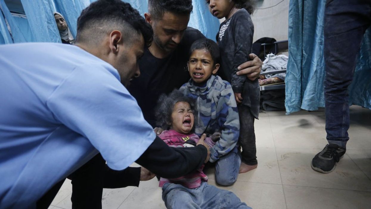 Doctors at Al-Aqsa Martyrs Hospital examine Palestinians