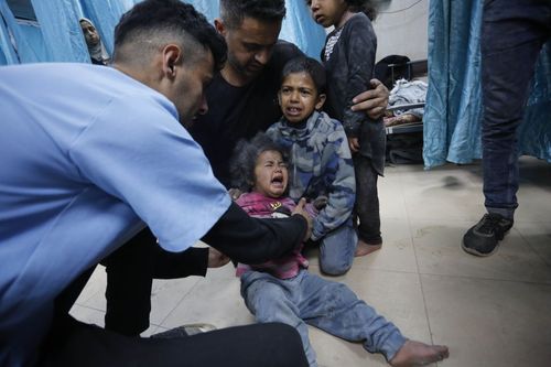 Doctors at Al-Aqsa Martyrs Hospital examine Palestinians