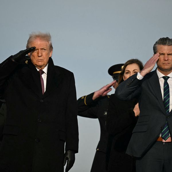 Donald Trump and Pete Hegseth salute