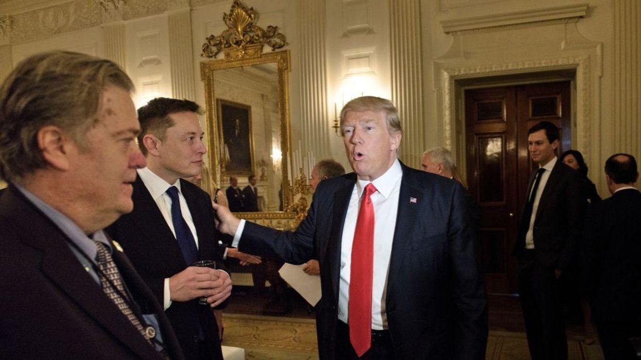 Donald Trump greets Elon Musk while Steve Bannon watches