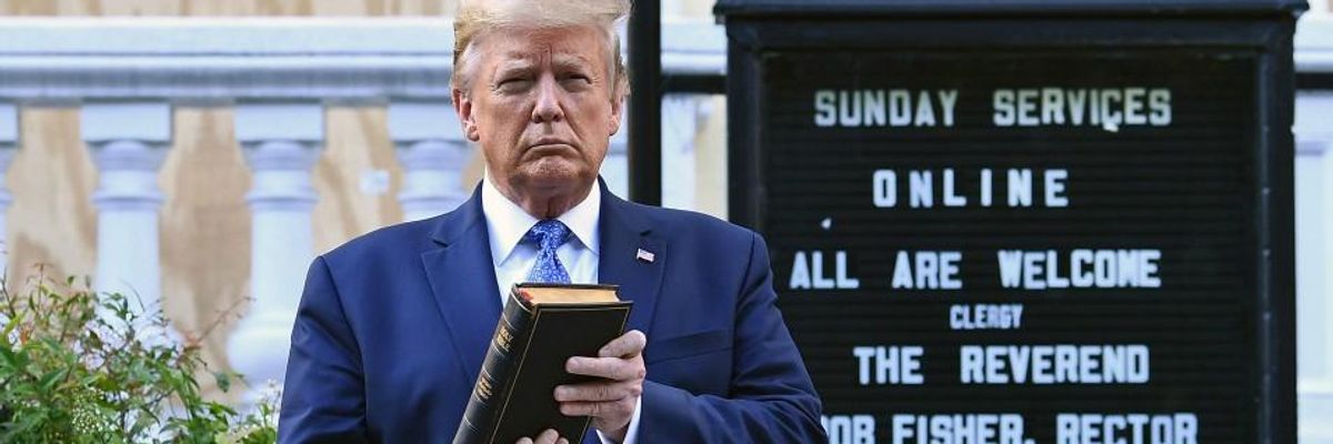 Donald Trump holds a bible outside a church