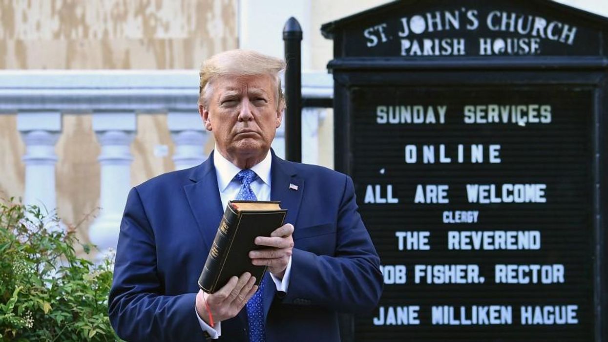 Donald Trump holds a bible outside a church