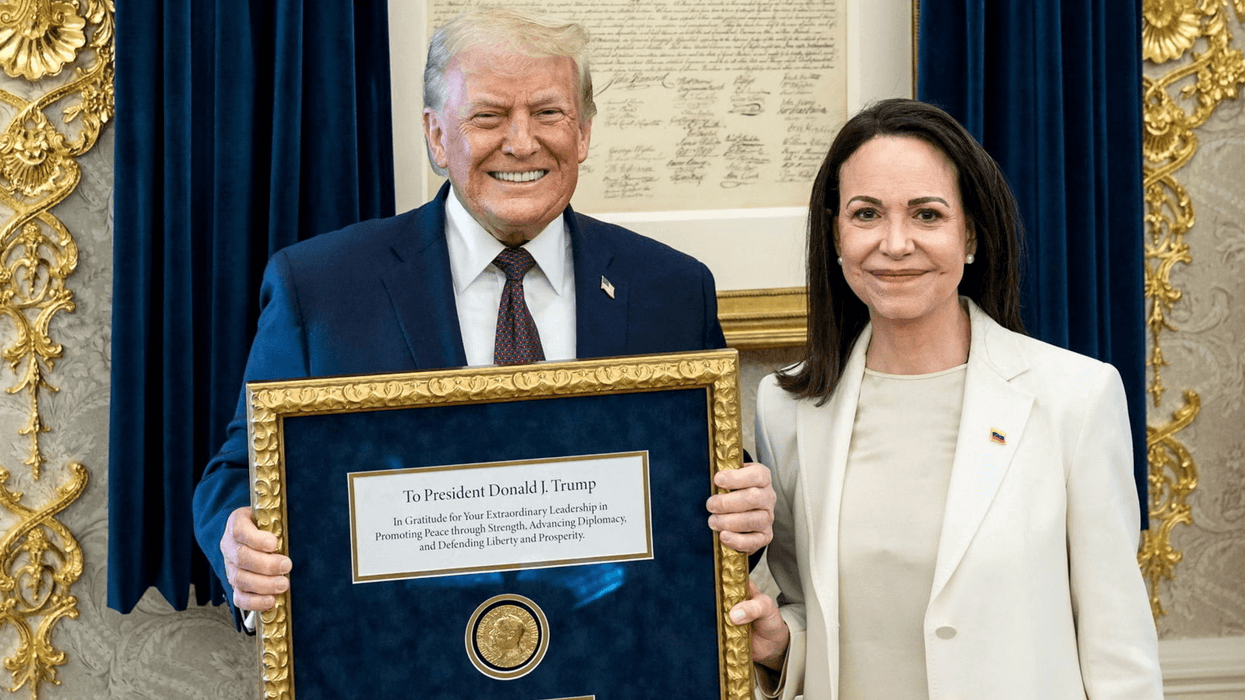 Donald Trump holds a framed Nobel Peace Prize given to him by winner María Corina Machado