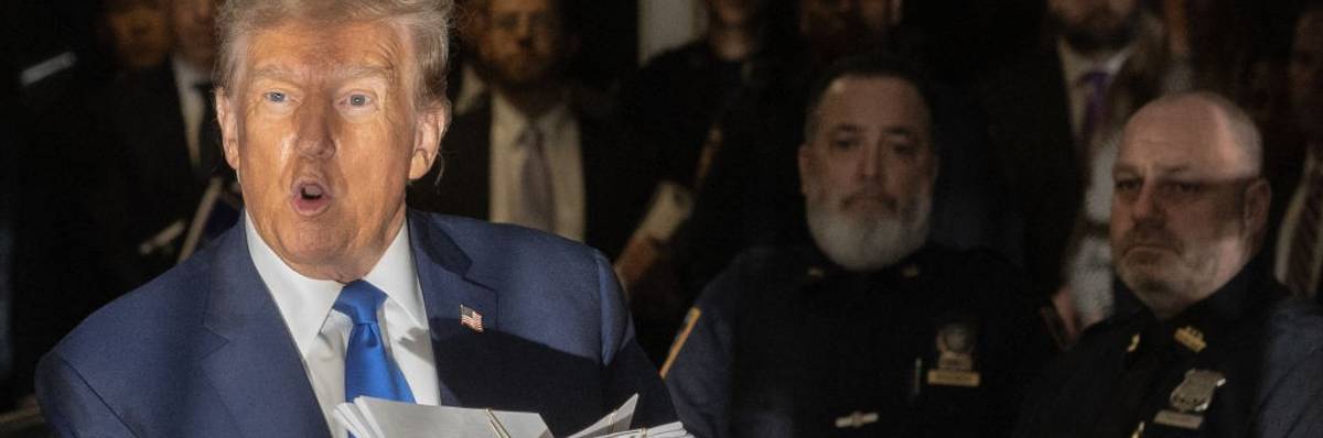 Donald Trump holds documents outside his New York trial