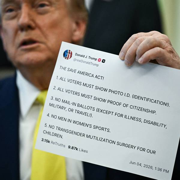 Donald Trump holds up a printout of one of his Truth Social posts