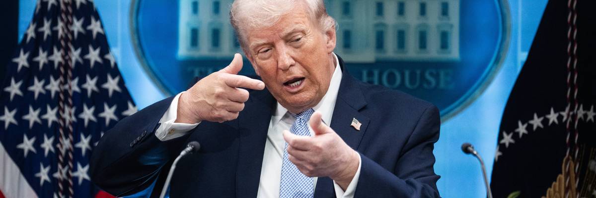 Donald Trump mimics firing a gun during a White House press conference