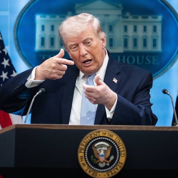 Donald Trump mimics firing a gun during a White House press conference